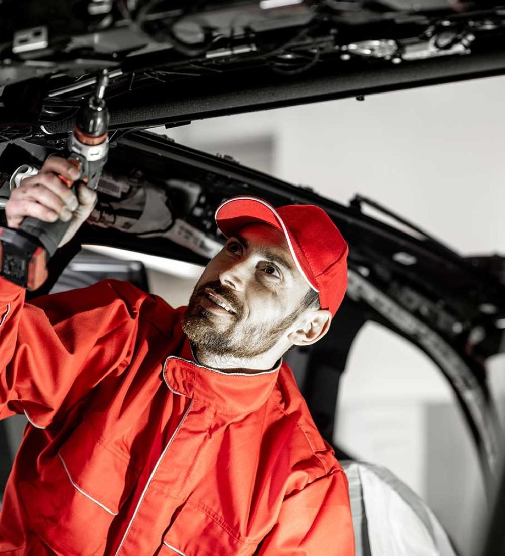 worker-disassembling-car-interior-2ECDQFR.jpg